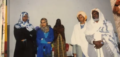 Three women and two elderly men standing