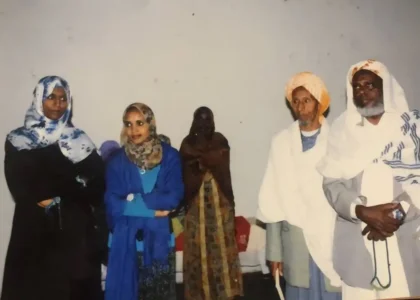 Three women and two elderly men standing