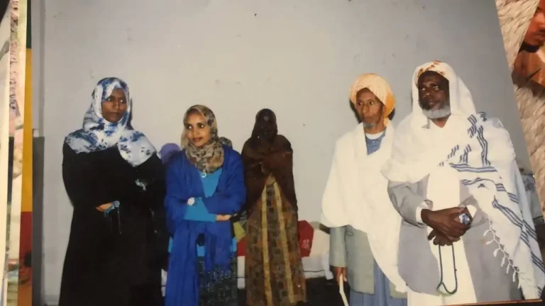 Three women and two elderly men standing